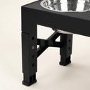Close-up of the adjustable leg notches on the elevated dog bowl stand