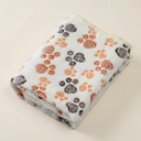 White fleece pet blanket with paw print design for cats & dogs, studio photo