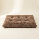 Brown soft plush dog and cat bed on a cream background