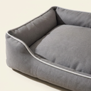 Close-up of the bite-resistant fabric and piping on the grey square dog bed