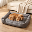 Dog resting on the grey waterproof square dog bed in a living room