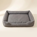 Grey waterproof square dog bed on a cream background
