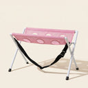 Pink foldable dog and cat grooming hammock on a cream background