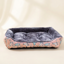 Pink square pet bed cushion on a cream background