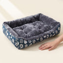 Square pet bed cushion next to a hand for size reference