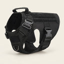 Black tactical dog harness on a cream background