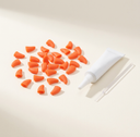 Orange soft nail caps for cats with adhesive glue, studio photo