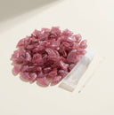 Pink soft nail caps for cats with adhesive glue, studio photo