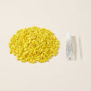Yellow soft nail caps for cats with adhesive glue, studio photo