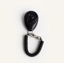 Black dog training clicker with adjustable wrist strap, studio photo