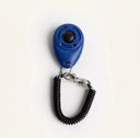 Blue dog training clicker with adjustable wrist strap, studio photo