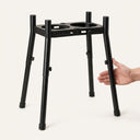 Elevated dog feeder next to a hand for size reference
