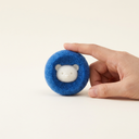 Blue reusable pet hair remover laundry ball for washing machines, scale photo