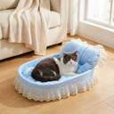 Blue plush oval cat bed with lace trim for small dogs & cats, lifestyle photo