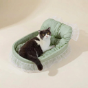 Green plush oval cat bed with lace trim for small dogs & cats, studio photo