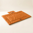 Orange portable waterproof chew-resistant mat for dogs & cats, studio photo