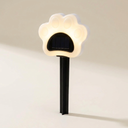 Warm white solar paw print garden light on a cream background