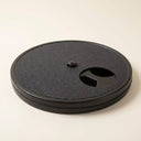 Black dog nail scratch board with snack compartment on a cream background