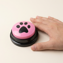 Talking dog button next to a hand for size reference